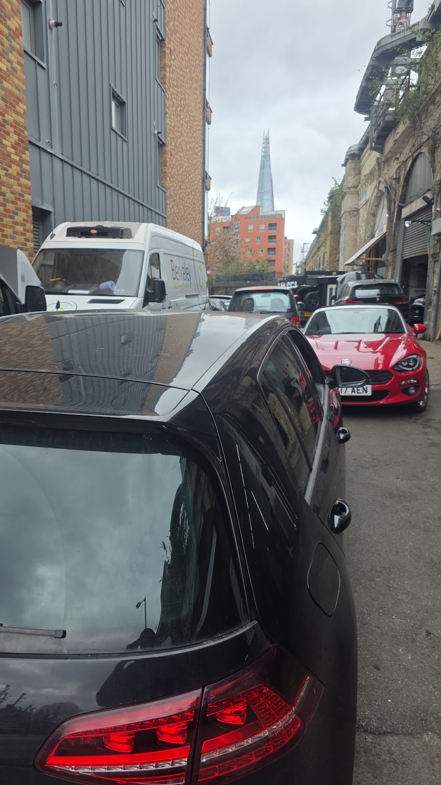 A white Rolls-Royce raised on the ramp inside QUANTUM TORQUE on Abbey St, under the workshop sign